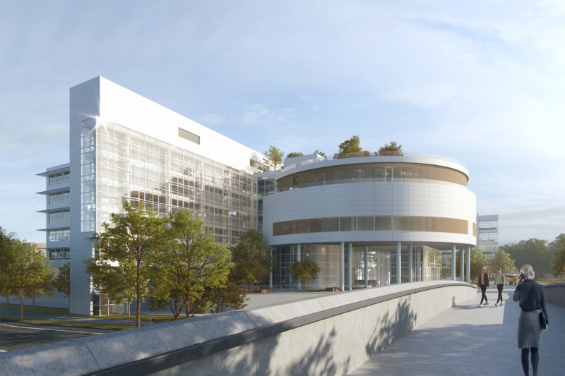 Auf der Visualisierung des AER in München ist das sonderbare Gebäude zu sehen. Ein zylindrischer Vorbau und ein daran anschließendes dünnes, langes Gebäude erstrahlen in hellem weiß.