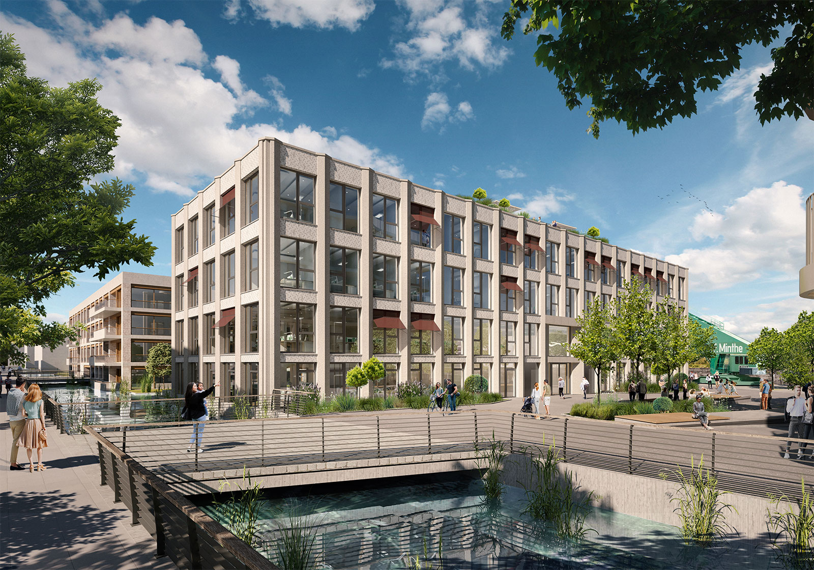 Gebäudeensemble Marina B am Wasser mit Klinkerfassade, Brücke und Grünflächen im Zollhafen Mainz