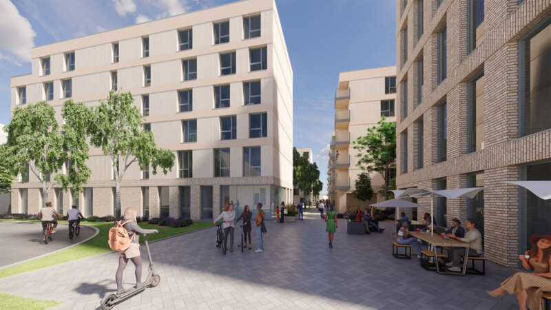 Belebte Quartiersgasse mit Radfahrern, Fußgängern und Außengastronomie zwischen mehrgeschossigen Wohnhäusern