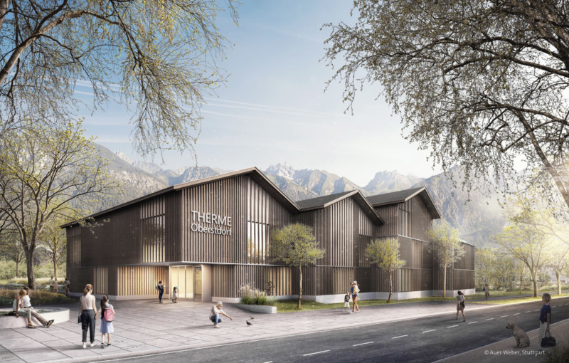 Die Visualisierung der Neuen Therme Oberstdorf zeigt das neue Gebäude mit Holzverkleidung vor einer Bergkette